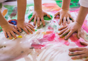 Close-up of children playing with paint