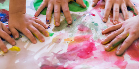 Close-up of children playing with paint